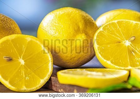 Top View Of Lemon And Green Leaves On Wooden Background