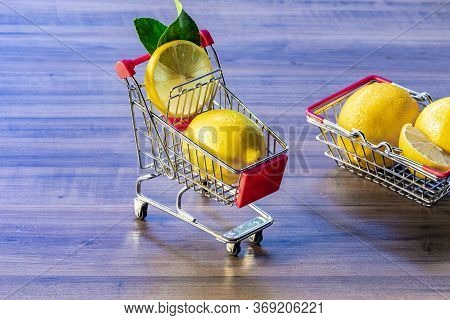 Top view of lemon and green leaves on wooden background