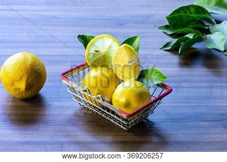 Supermarket cart carrying green leaf and lemon