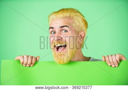 Red Head Funny Man Holding A Banner. Insert Text Or Slogan. Caucasian Blond Male Model Posing In Fas