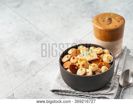 Mini Pancakes Cereal And Dalgona Coffee On Gray Cement Background, Copy Space. Trendy Food And Drink