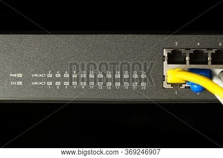 Network Switch And Ethernet Cable In Rack Cabinet. Network Connection Technology Thrue Cat6 And Cat5