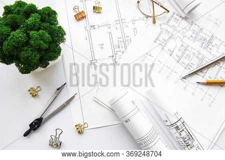 Architect Workplace Top View. Architectural Project, Blueprints, Blueprint Rolls On Table. Construct