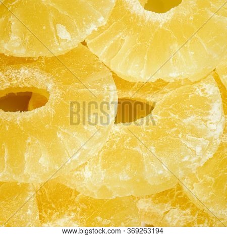Dried Pineapple Candy Rings, Close-up. Yellow Pineapple Sweets Cut In Round Slices In Powdered Sugar