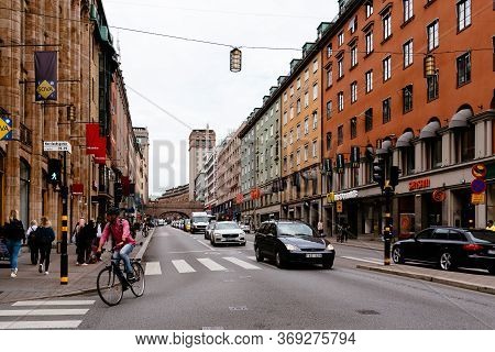 Stockholm, Sweden - August 8, 2019: Street Scene In City Centre With Ciclist And Cars. Norrlandsgata