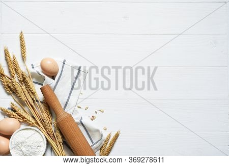 Baking Background With Flour, Wheat Ears And Rolling Pinon Concrete Background. Top View With Copy S