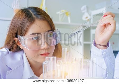 Doctor And Microbiologist With Vacuum Tubes For Samples With Covid 19 Infection Atypical Pneumonia V