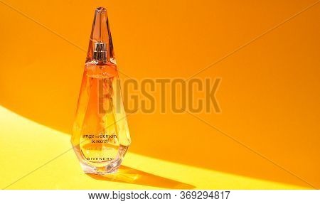 Zhytomyr, Ukraine - June 2, 2020. A Clear Orange Glass Spray Bottle Of Givenchy Ange Ou Demon Le Sec