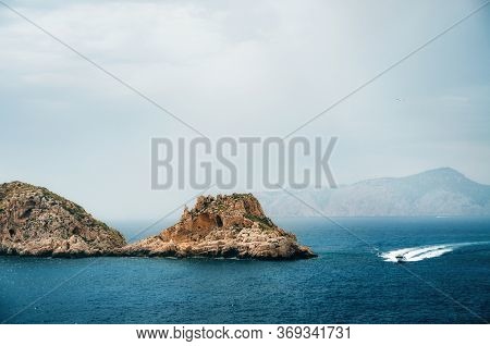 The Yacht Sails Near The Rocks Of Santa Ponsa In The Mediterranean Sea Before The Storm, Mallorca Is