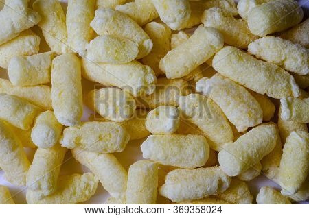 Airy Crisps, Corn Puffs, Puffcorn Snacks Background. Detailed Shot Of Ready-to-eat Puffcorn. Crispy 