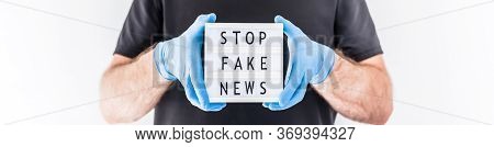Fake News Infodemics During Covid-19 Pandemic Concept. Man Wearing Protective Mask And Medical Glove