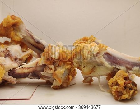 Waste Chicken Bone On A White Background Close-up, Bones In A Food Box.