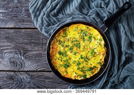 Omelet With Zucchini, Leek, And Carrot Served On A Frying Pan On A Rustic Wooden Background Sprinkle
