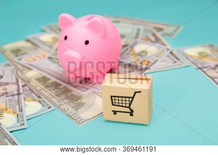 Pink Piggy Bank, Delievery Box And Dollar Banknotes On Blue Bakground. Online Shopping And Delivery 
