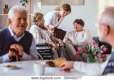 Older People Spening Time With Friends In The Living Room In A Nursing Home