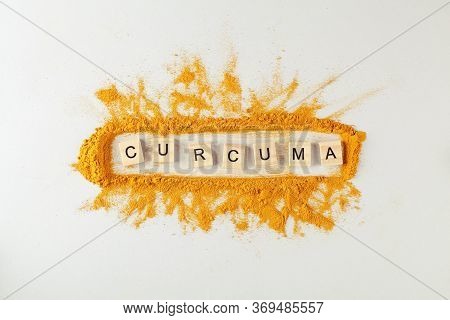 Text Curcuma And Turmeric Powder On Gray Background
