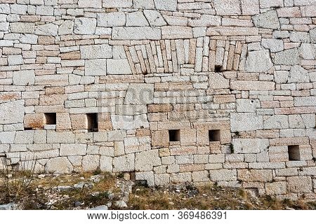 Closeup Of An Austrian Fortified Wall Made Of Irregular Stone Blocks With Arrowslits Or Loopholes