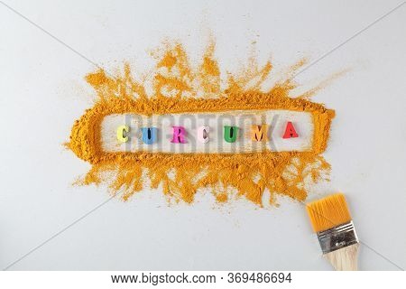 Text Curcuma And Turmeric Powder On Gray Background