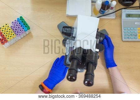 Laboratory Assistant Is Looking Through A Microscope. Close-up Doctor Laboratory Assistant Looking T