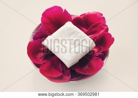 Cloth Menstrual Pads. Reusable Cloth Daily Pads On Red Petals On White Background. Zero Waste Suppli