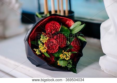 Bouquet Of Flowers In Black Package. Rose, Green Carnation, Asclepius, Capsicum, Skimmy.