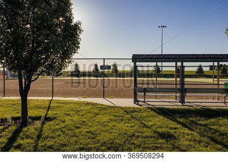 A Baseball Diamond In A Park Where Games Should Be Played But Now Only Has Practices