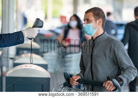 Temperature Check At A Supermarket Of Man, Grocery Store With Thermal Imaging Camera. Image Monitori