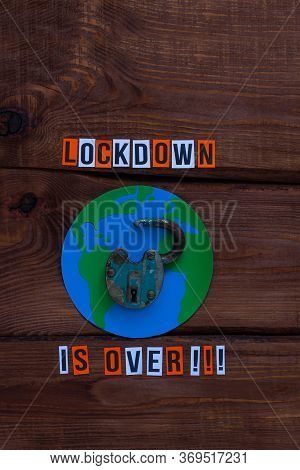 Lockdown Is Over Sign, Open Iron Lock On Wooden Background. Opening Borders Between Countries. End O