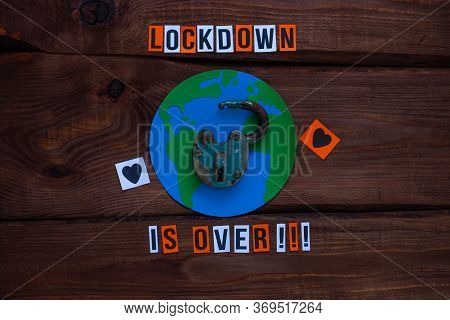 Lockdown Is Over Sign, Open Iron Lock On Wooden Background. Opening Borders Between Countries. End O