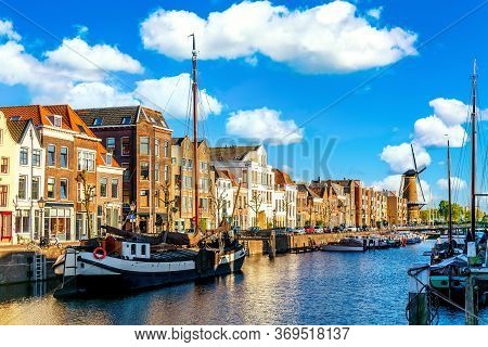 Old Historic District Delfshaven With Wildmill And Houseboats In Rotterdam, South Holland, The Nethe