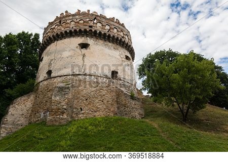 The Round Tower Of The Ostrog Castle In Western Ukraine. Bottom View Of The Walls, Rivne Region, Ukr