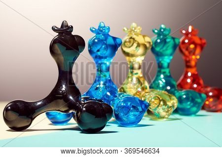 Five Hand Masseurs Called Pharaoh, Of Different Colors, Stand In One Row, Behind Each Other, On A Br