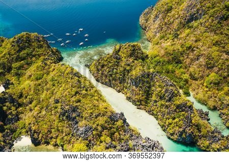 Palawan, Philippines Aerial View Of Tropical Miniloc Island. Tourism Trip Boats Moored At Entrance T