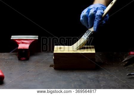 Hand Varnishing Handcrafted Wooden Box On Black Background, Concept Of Repair.