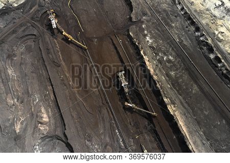 Aerial Shoot Of Quarry With Heavy Bucket Wheel Excavators Mining A Coal. Heavy Industry Concept.