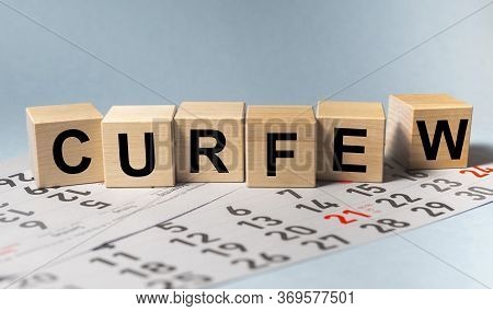 Curfew Word Text On Cube Blocks On Calendar. Curfew Order Concept