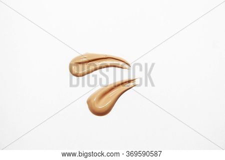 Liquid Foundation For Makeup. Two Foundation Smudge On A White Background.