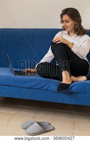 Woman Working On Laptop At Home Office While Drinling Coffee. Web Conection
