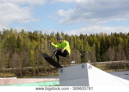 Fagersta, Sweden - Maj 26, 2020: Wakeboarder Flies In The Air On Wakeboard. Wakeboarding Is Extreme 