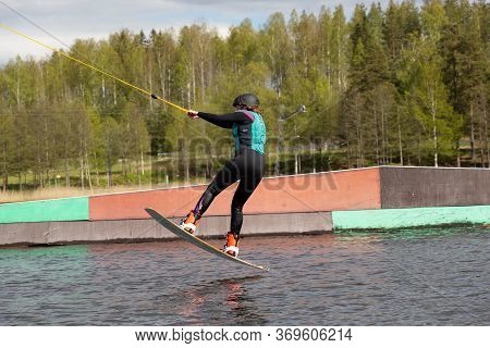 Fagersta, Sweden - Maj 26, 2020: Wakeboarder Flies In The Air On Wakeboard. Wakeboarding Is Extreme 