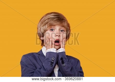The Frightened Boy Is Blond, His Hands Are Near His Face. Strict Suit.