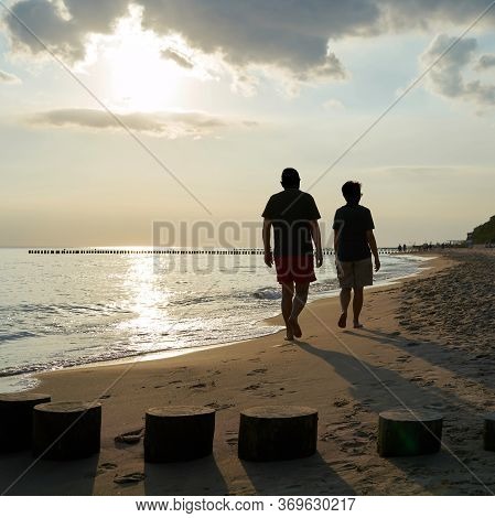 Holidaymakers On The Beach Of The Polish Baltic Sea Near Rewal During A Beach Walk
