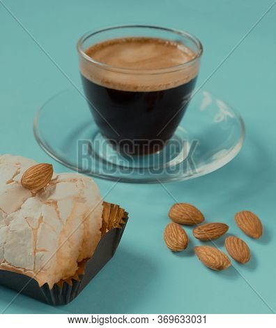 A Glass Cup Of Black Coffee With Merinque Cake And Almond. Beautiful Breakfast.