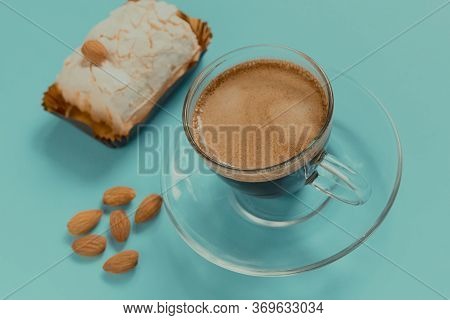 A Glass Cup Of Black Coffee With Merinque Cake And Almond. Beautiful Breakfast.