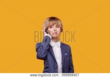The Kids Talking On His Cell Phone. A Business Conversation On The Phone.