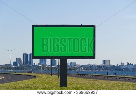 Chroma Key Billboard On A Background Of Cityscape And Sea. Suitable For Advertising. Blank Billboard