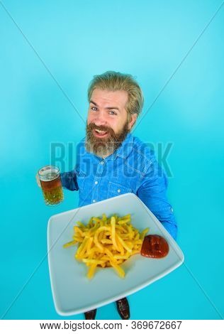 Man With Potato Fries. Beer. Fast Food. French Fries Potato. Man Drinking Beer And Eating Potato Fri
