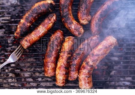 Sausages Grilled On A Charcoal Barbeque. Top View Of Tasty Barbecue, Food Concept, Food On Grill And