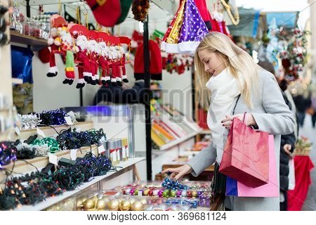 Girl Shopping At Festive Fair Before Xmas At Christmas Market