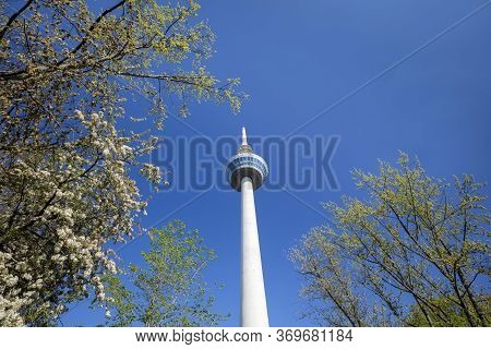 Mannheim. Germany. - April 19, 2019: Tv Tower In Mannheim Against The Blue Sky And Flowering Trees. 